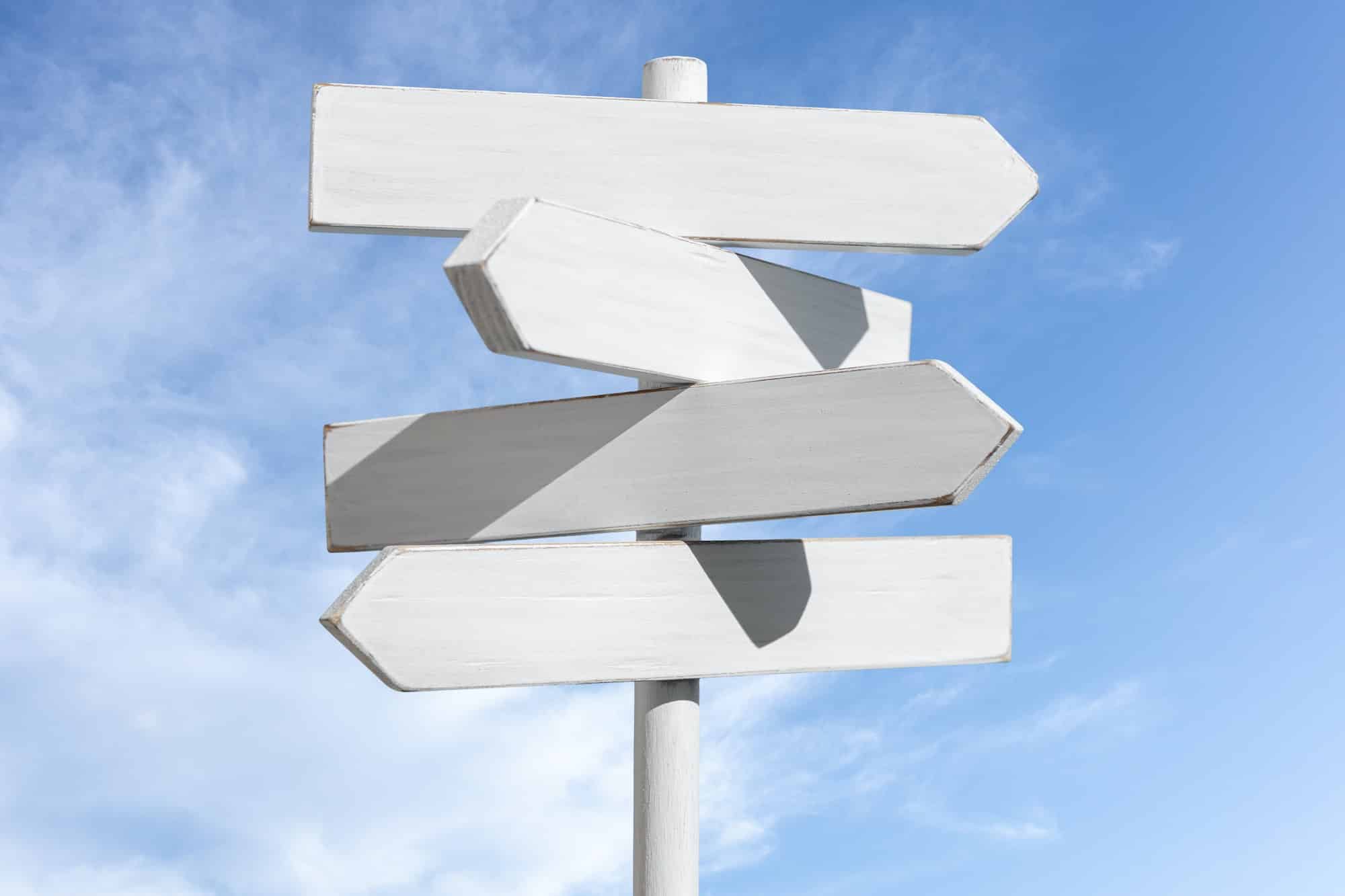 Blank white signpost on blue sky background